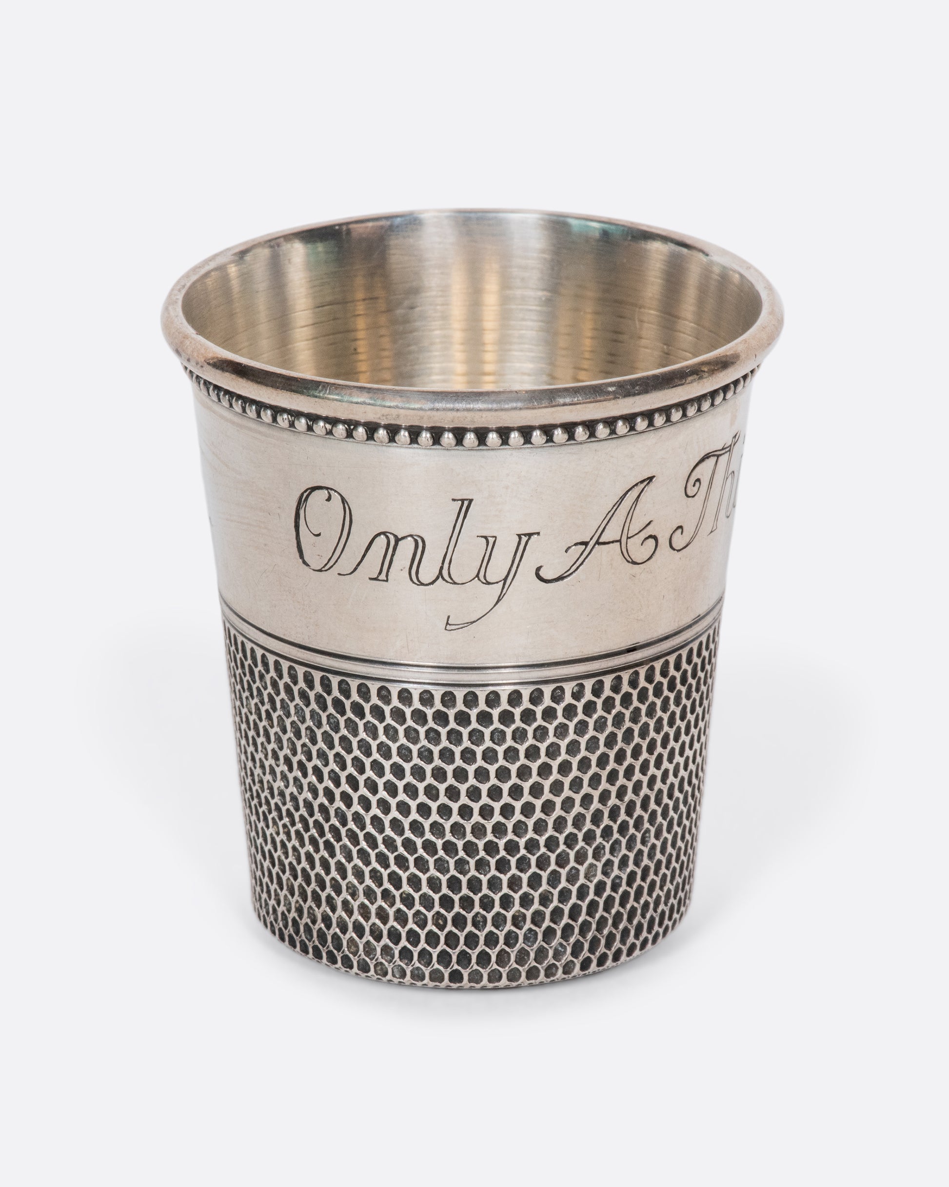 This rare sterling silver vintage shot glass is engraved with "Only a thimble full". A cheeky, yet elegant addition to any bar.