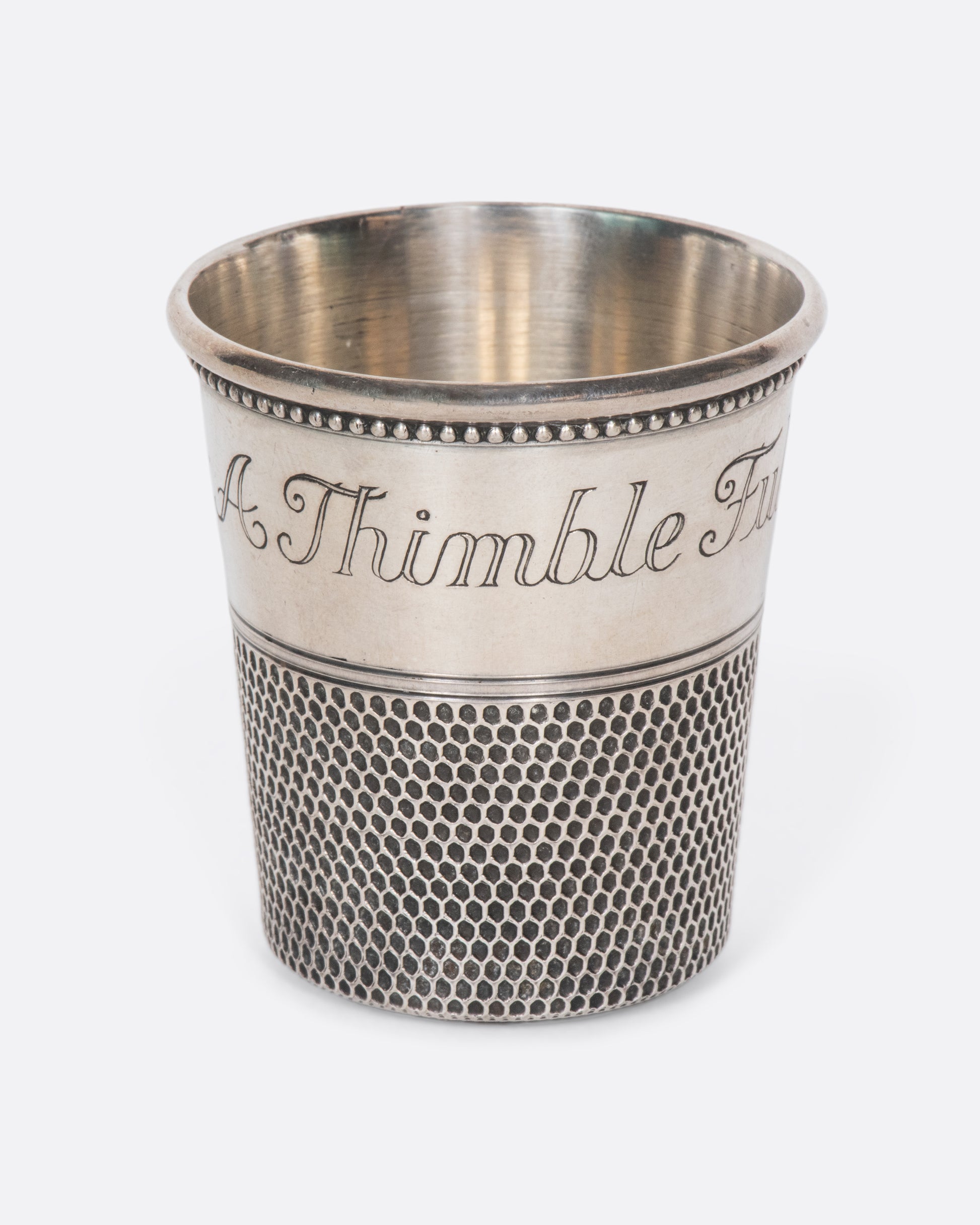 This rare sterling silver vintage shot glass is engraved with "Only a thimble full". A cheeky, yet elegant addition to any bar.