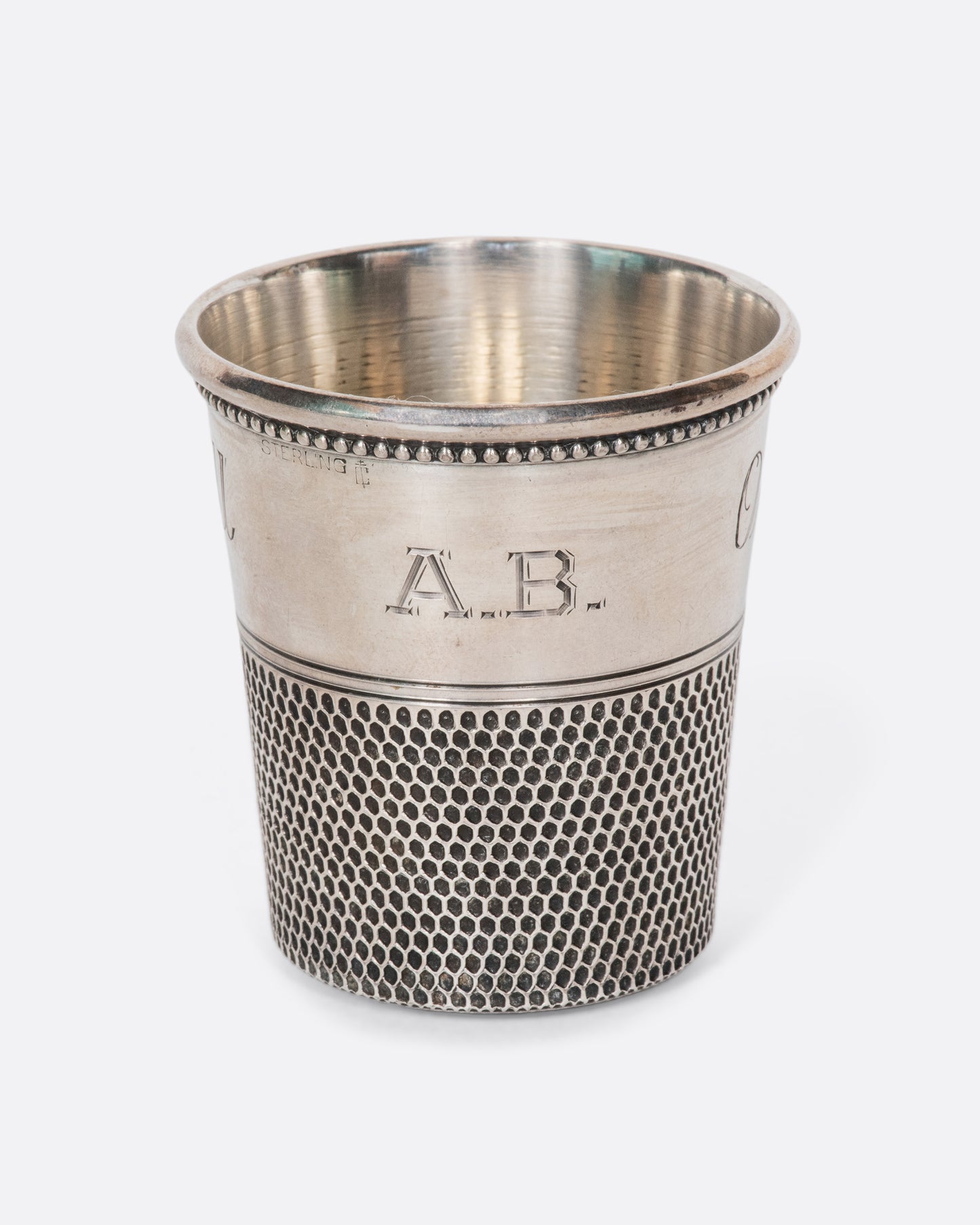 This rare sterling silver vintage shot glass is engraved with "Only a thimble full". A cheeky, yet elegant addition to any bar.