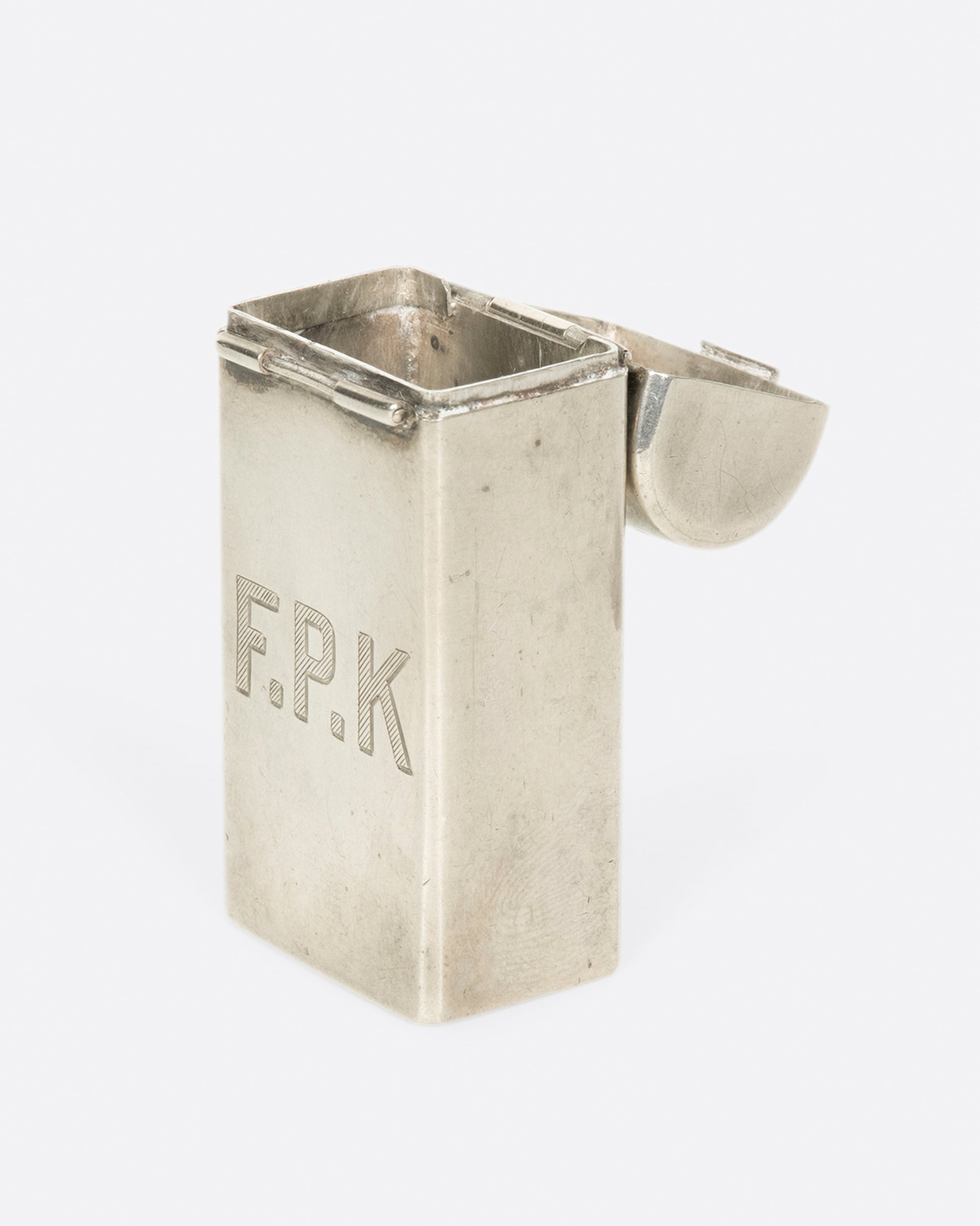 A vintage monogrammed toothbrush holder from Tiffany & Co. A one-of-a-kind gift for your favorite F.P.K.