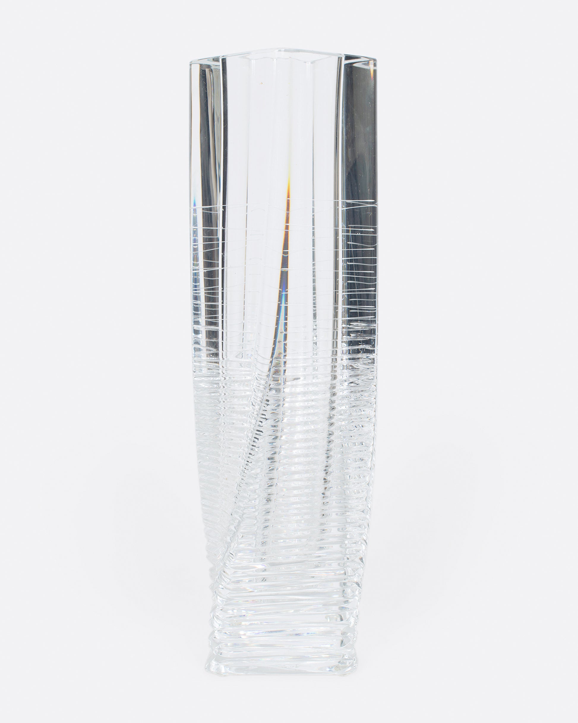 A fantastic, heavy clear glass textured vase. The vase itself is subtly twisted and has glorious rainbows throughout. A magical piece to put in a sunny spot and a Lori favorite!