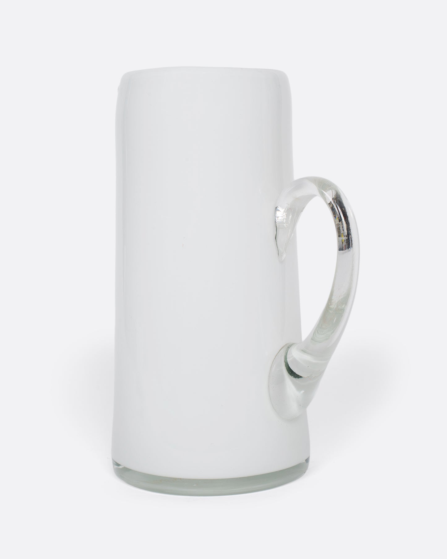 A vintage white cased glass pitcher. Two layers of white glass add depth to its color, creating an elegant, sleek look.