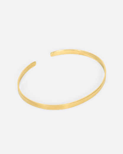 Vintage yellow gold narrow cuff bracelet, angled view of the open cuff