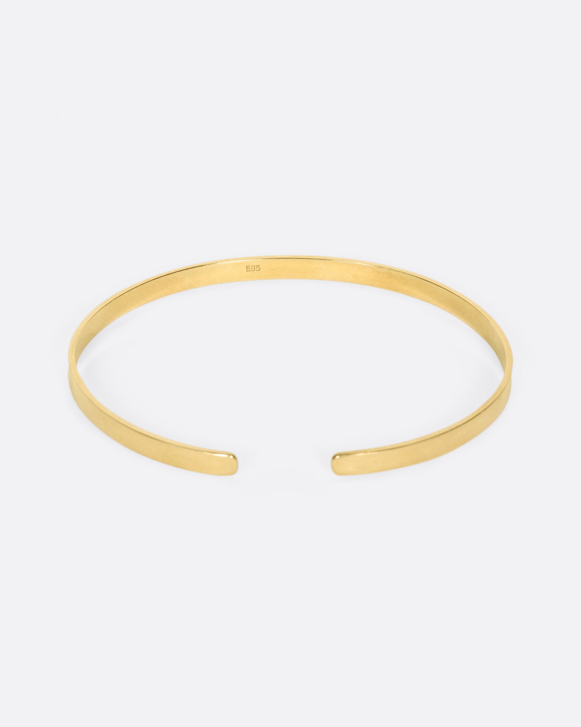 A flat ribbon of gold that looks like a bangle if you wear it face down, but still has all of the flexibility of a cuff.