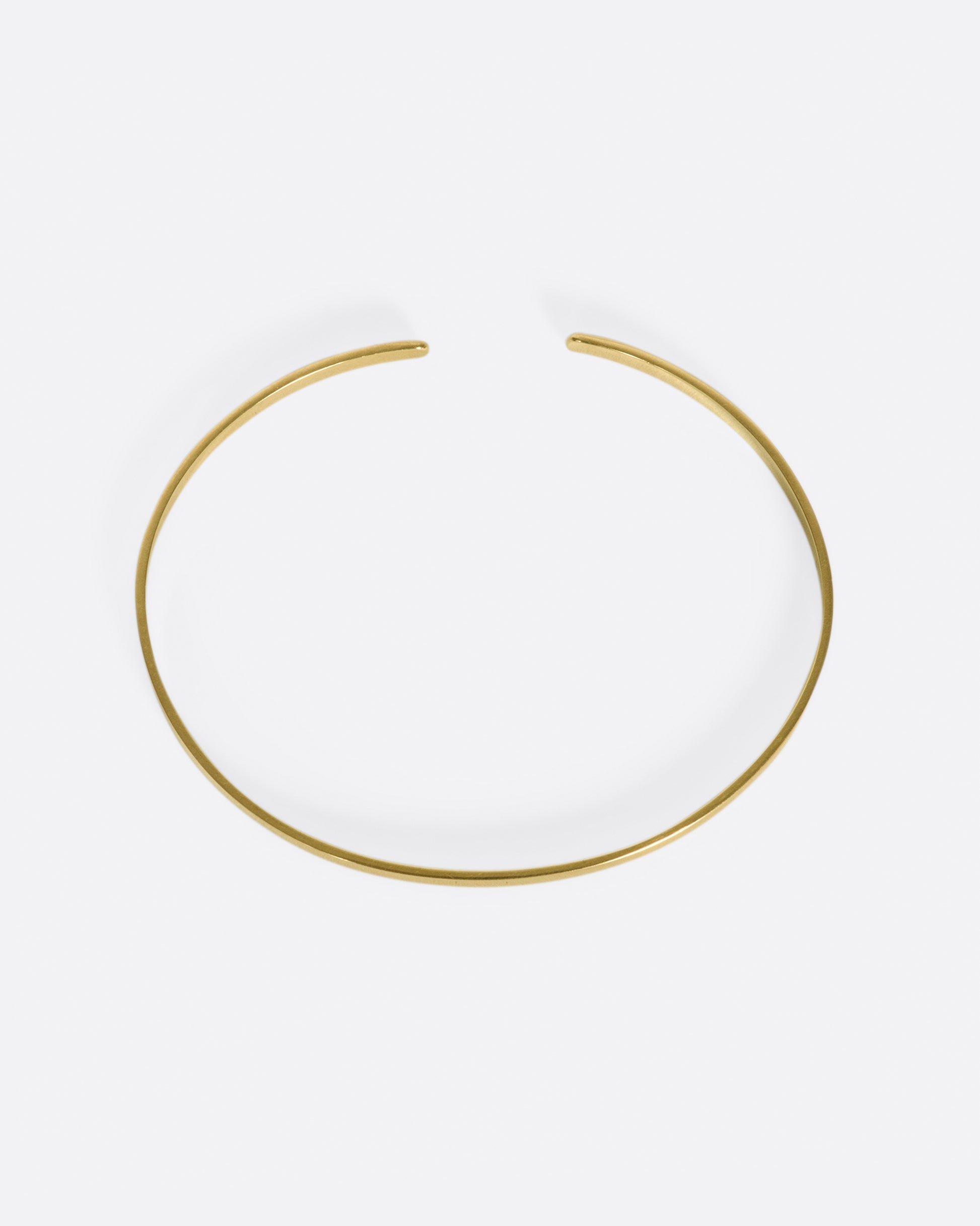 A flat ribbon of gold that looks like a bangle if you wear it face down, but still has all of the flexibility of a cuff.