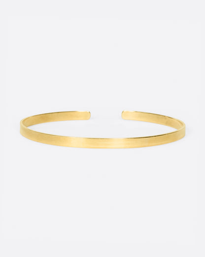 Vintage narrow cuff bracelet in 14k yellow gold, a slim flat band with an open front