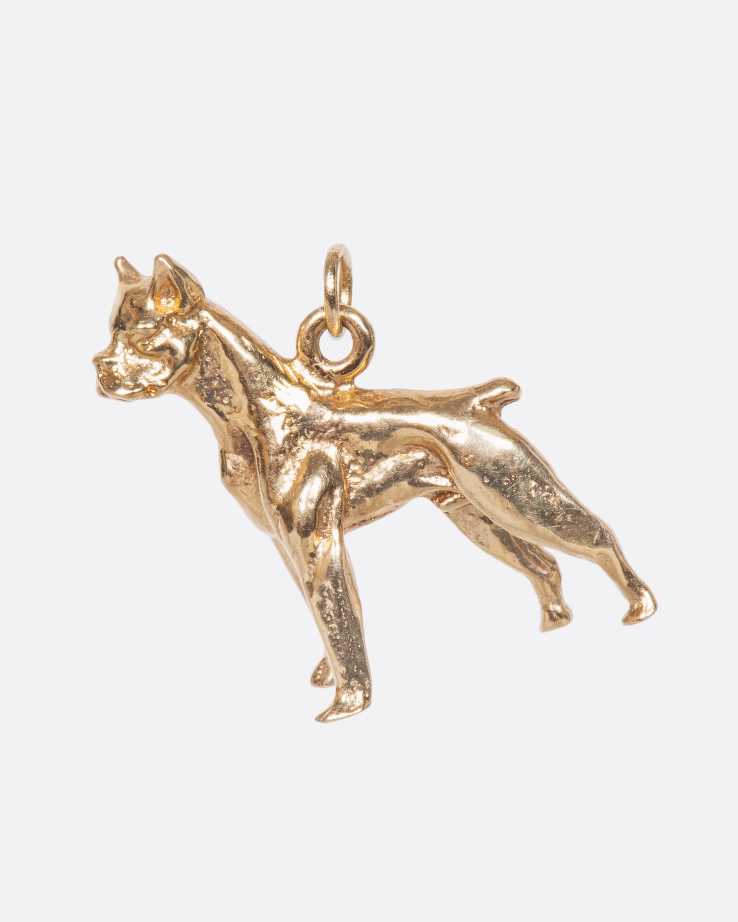 A vintage yellow gold boxer carved with life-like detail. It's unique on each side and stands on its own