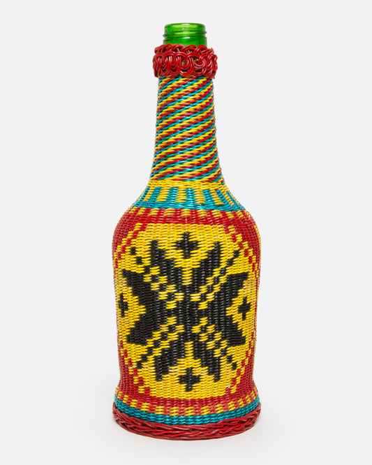 A glass Hungarian Miner's Bottle with a colorful pattern of woven electrical wire on top, shown from the front.