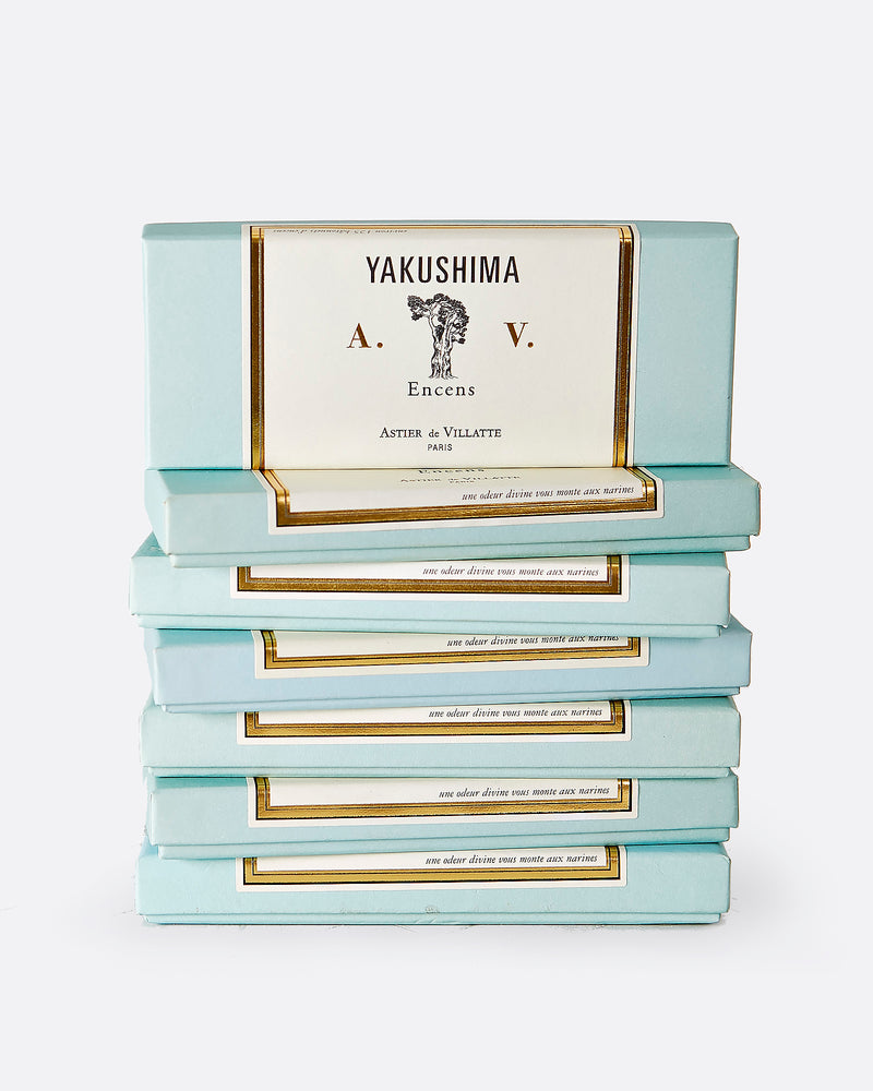 A stack of seven turquoise and white incense boxes with gold details.The top box is shown standing up from the front on top of the stack. The label reads: 'YAKUSHIMA A.V. Encens ASTIER de VILLATTE PARIS' with the image of a tree at the center.