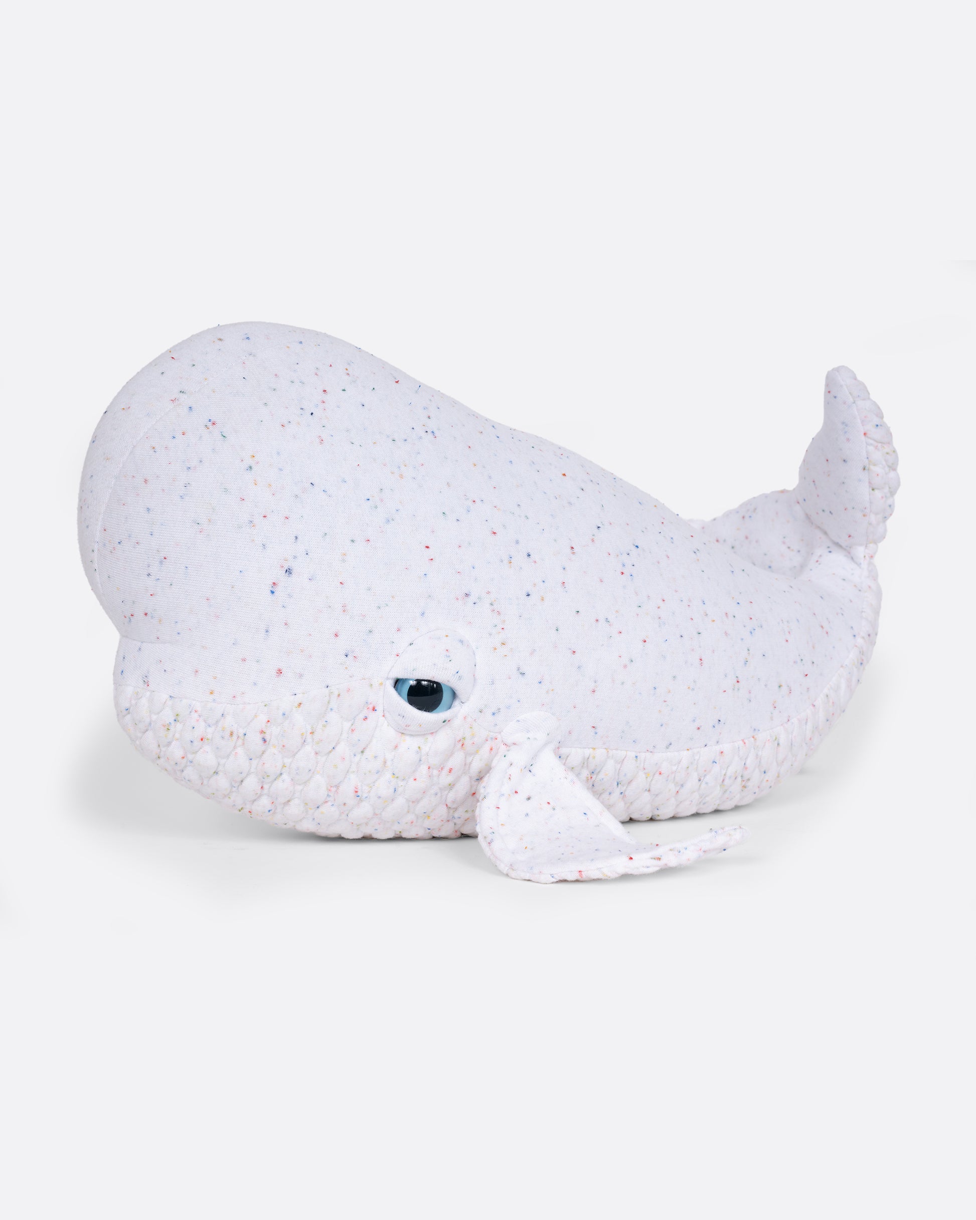 A confetti speckles white beluga whale stuffed animal shown from the side.