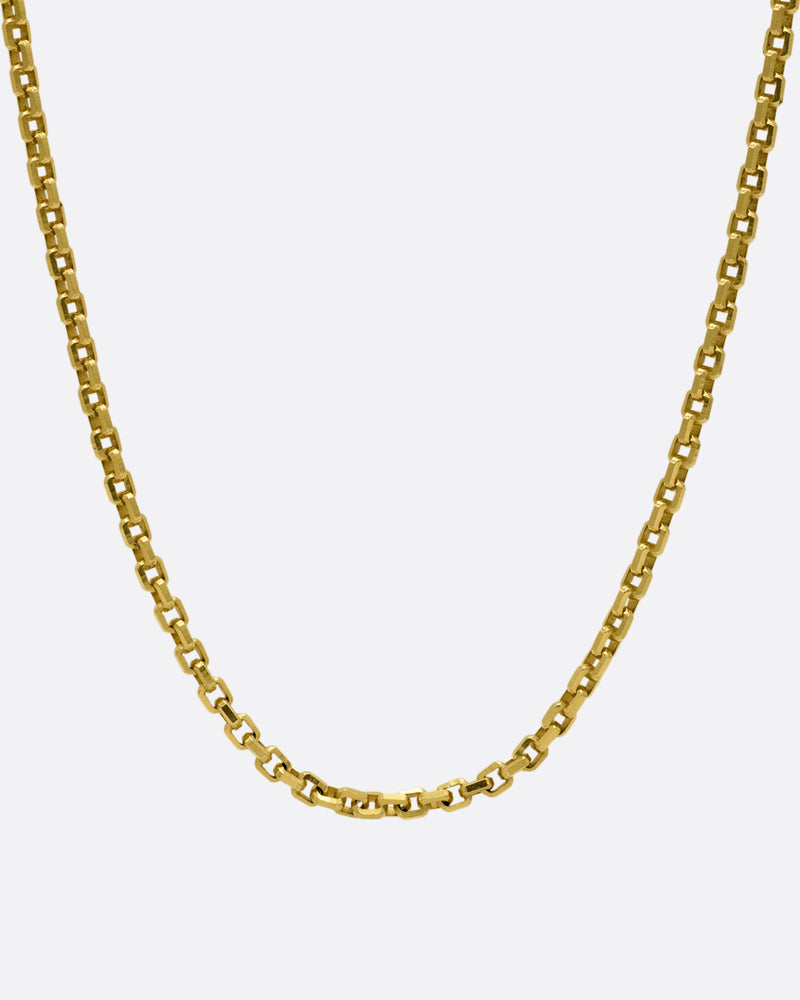 A yellow gold square link necklace, shown from the front.