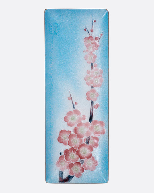 A rectangular blue dish with a pink cherry blossom design, shown from the top.