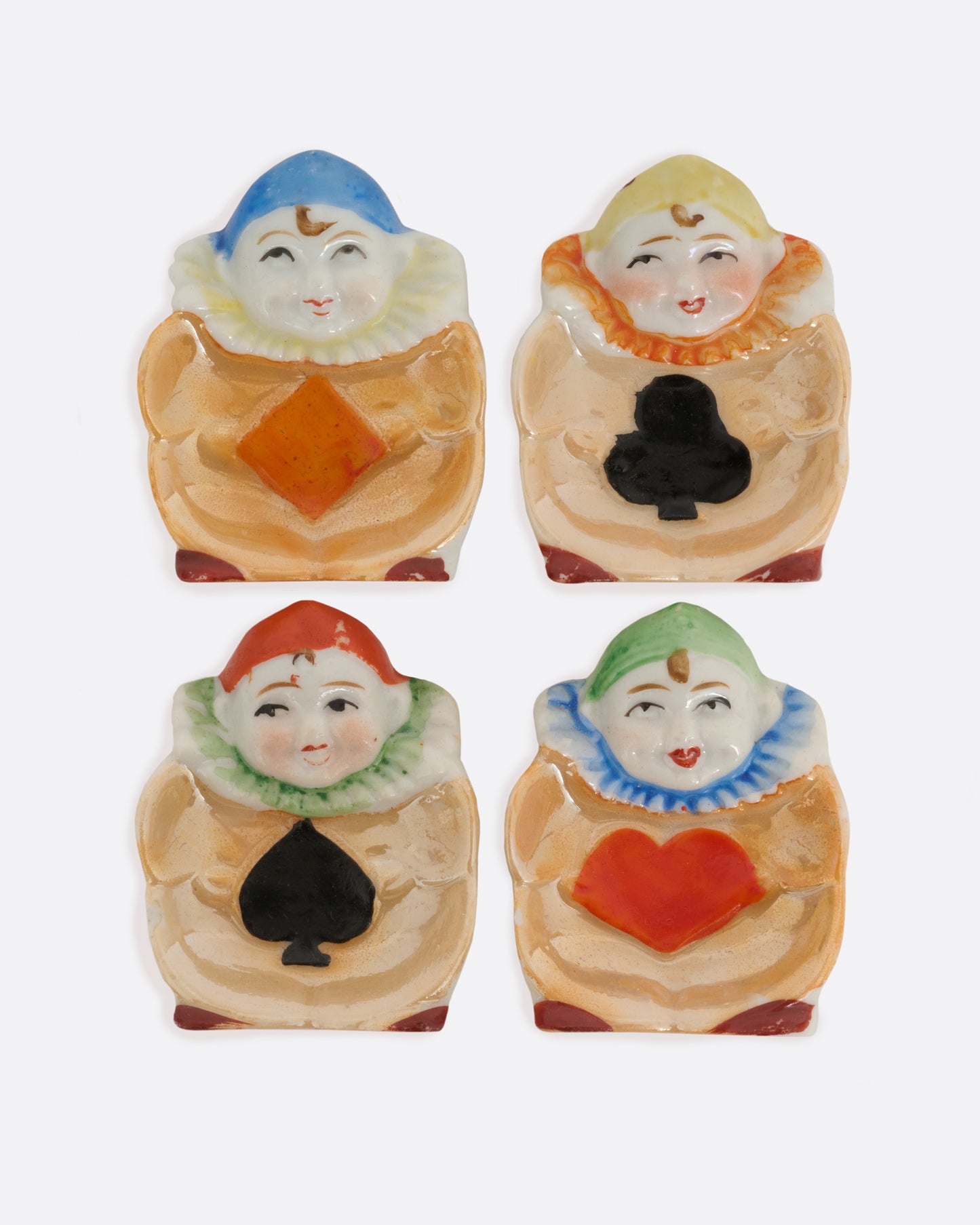 A set of 1940's Japanese harlequin clown dishes with card suit costumes. Shown from the top.