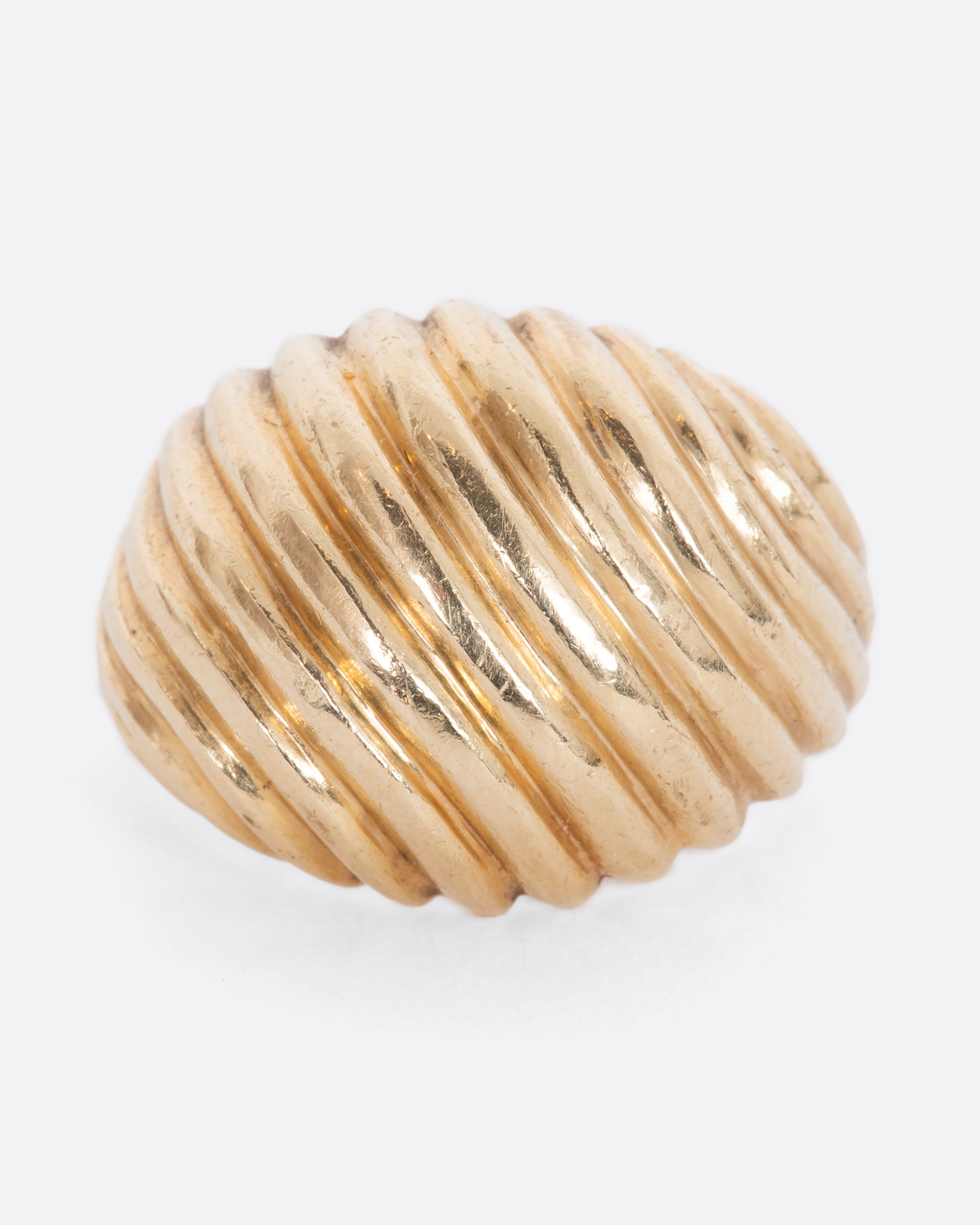 Yellow gold dome ring with diagonal ribbing. View from the front.