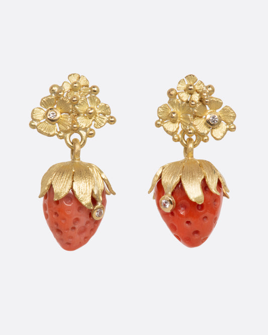 Yellow gold earrings with carved strawberry dangles with diamond details. View from the front.