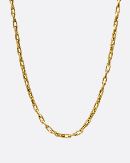 A yellow gold box chain with elongated links, shown from the front.