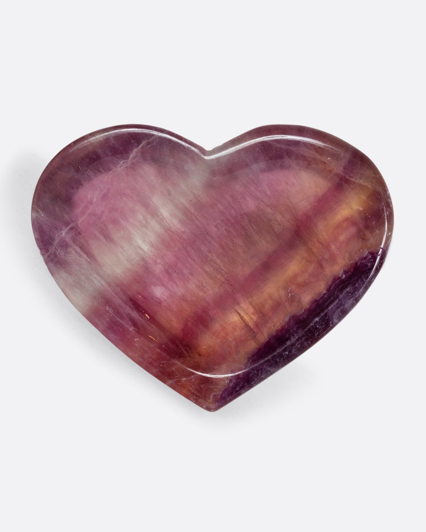 A flourite stone bowl in the shape of a heart. Shown from the front.