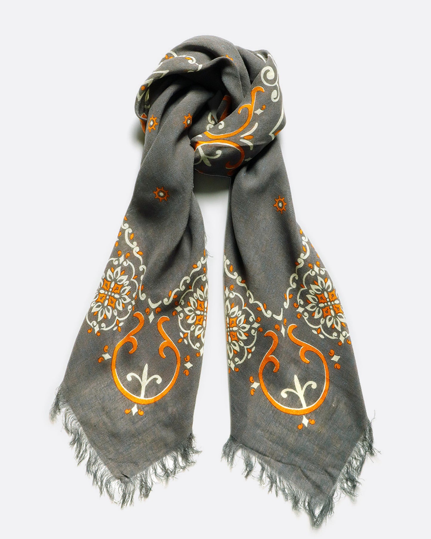 A lightweight grey scarf with fringe border. View tied.