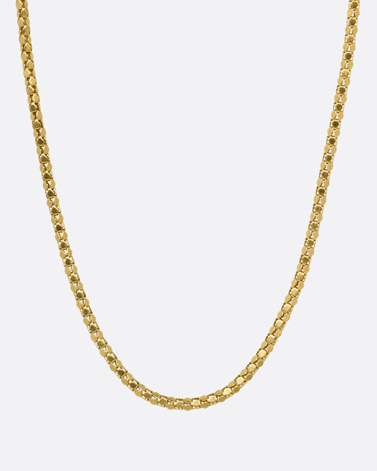 A yellow gold tube chain necklace, shown from the front.