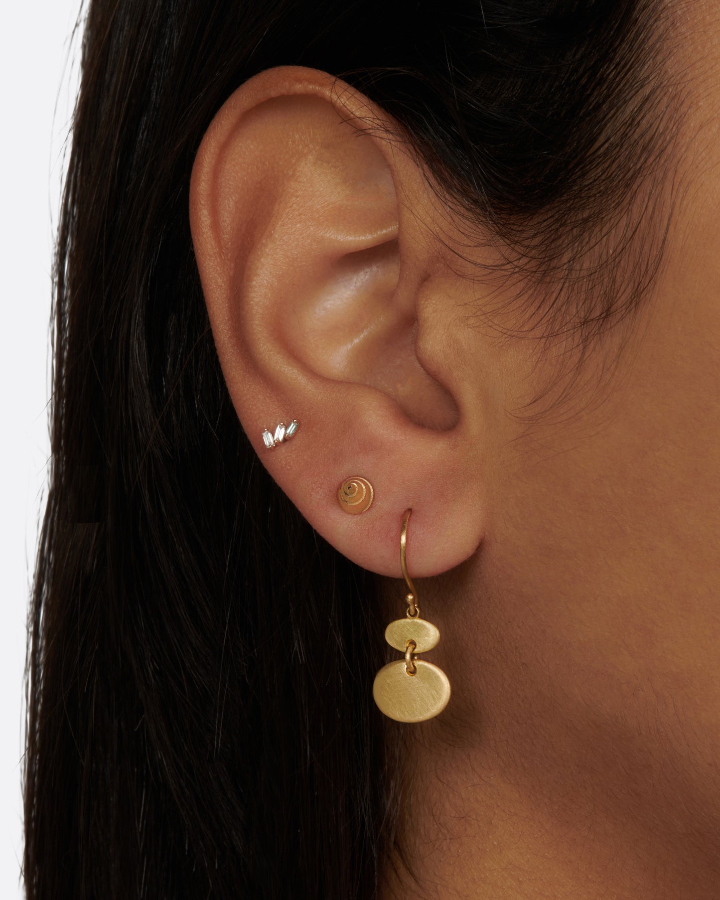 A pair of matte gold sequin earrings with great movement.