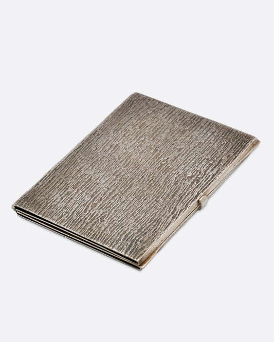 A silver picture frame with a textured exterior, shown closed.