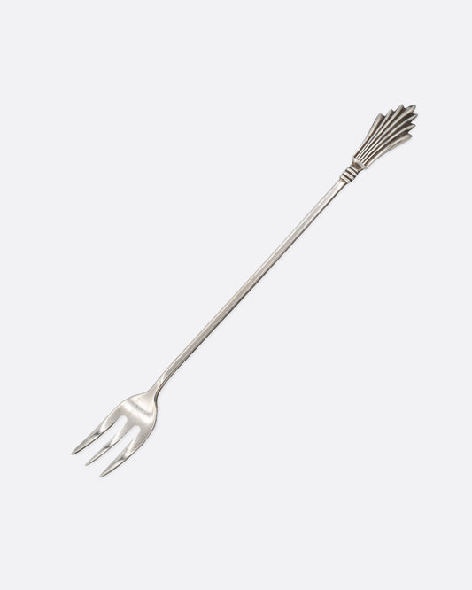A silver three pronged fork with a fan shape at the top of the handle. Shown from the front.