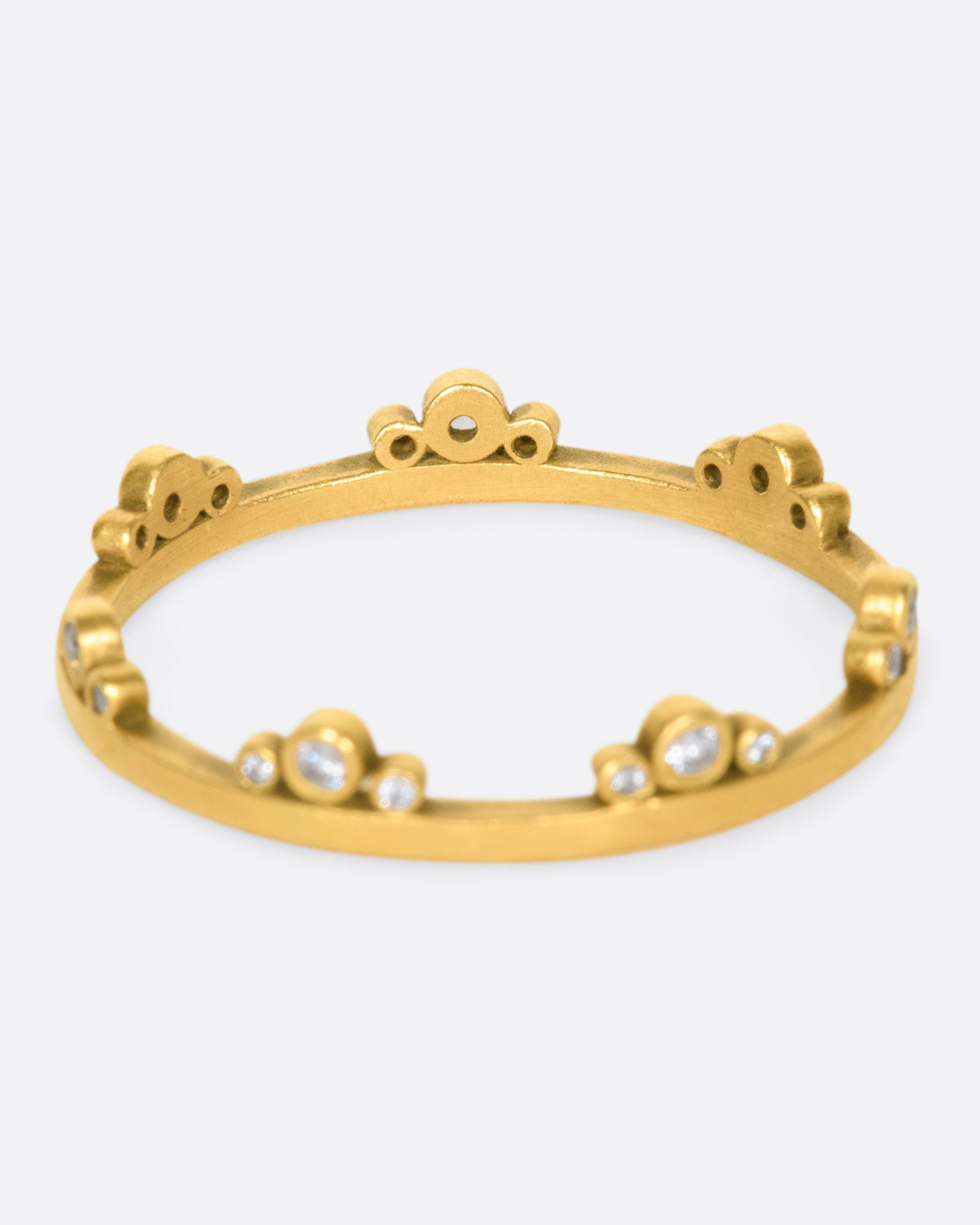 A matte gold band crowned with seven trios of diamonds.