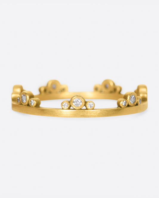 A matte gold band crowned with seven trios of diamonds.