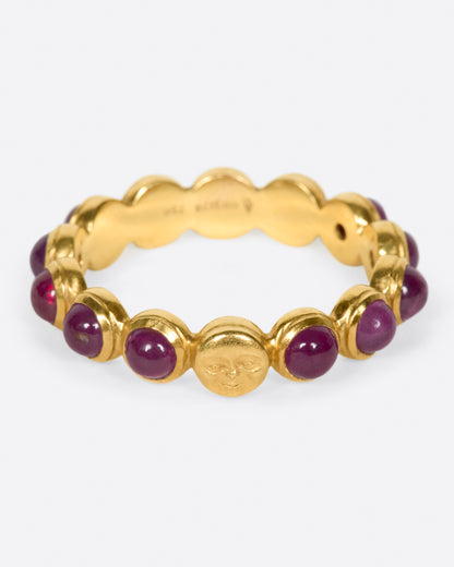 Yellow gold ruby band with moon face, angled view of the moon face and rubies set all the way around
