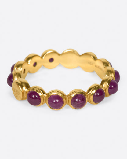 Yellow gold ruby band with moon face, side view of the band showing the ruby cabochons