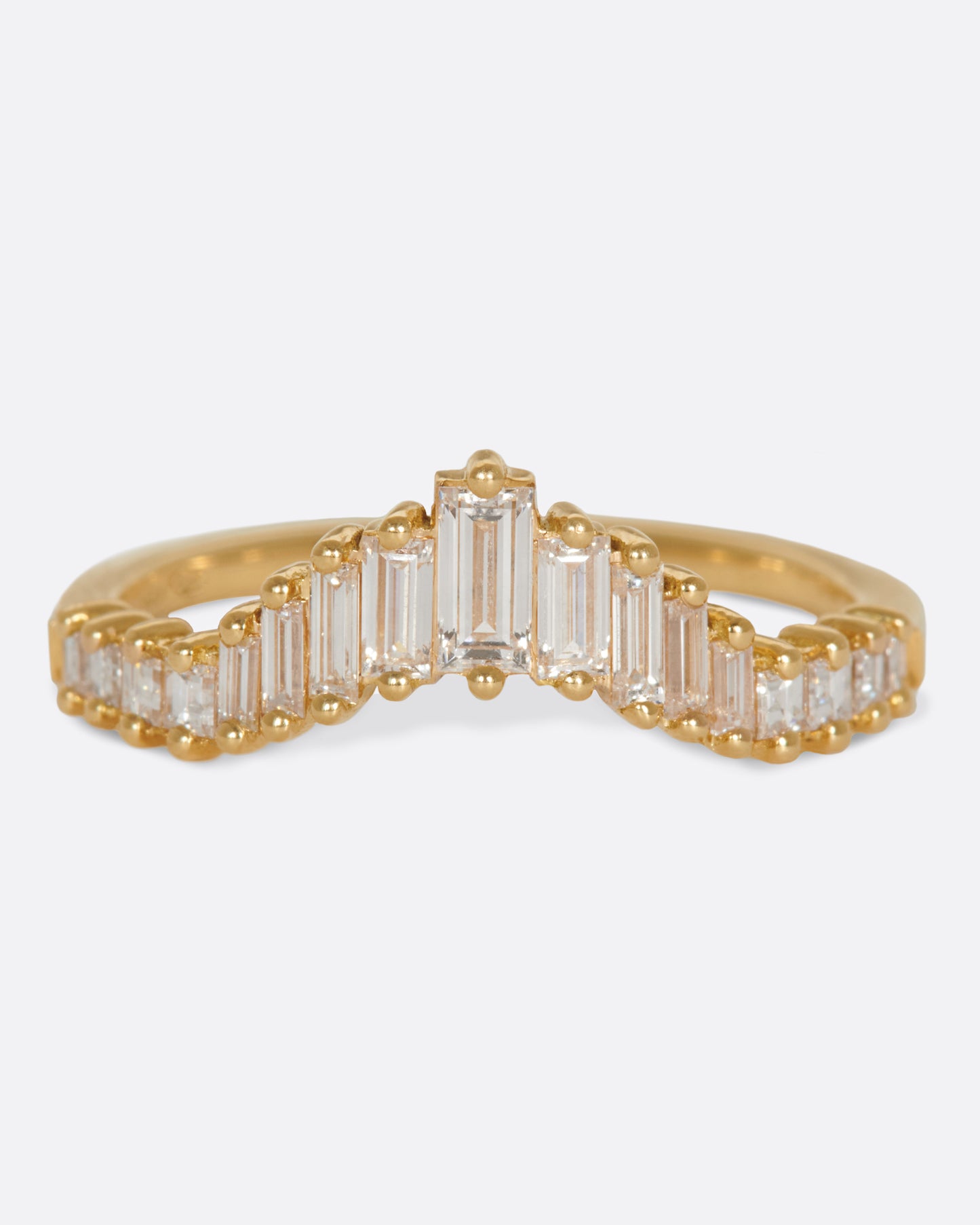 A curved crown ring lined with baguette diamonds.