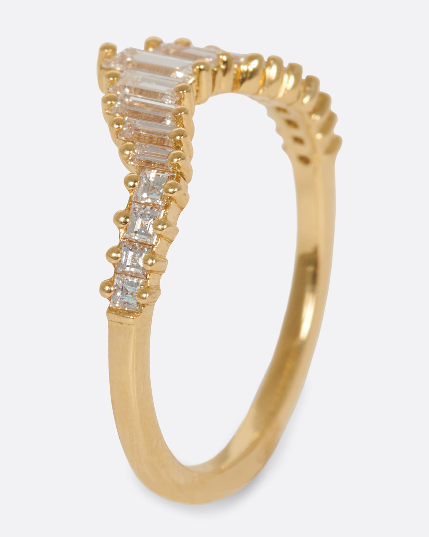 A curved crown ring lined with baguette diamonds.