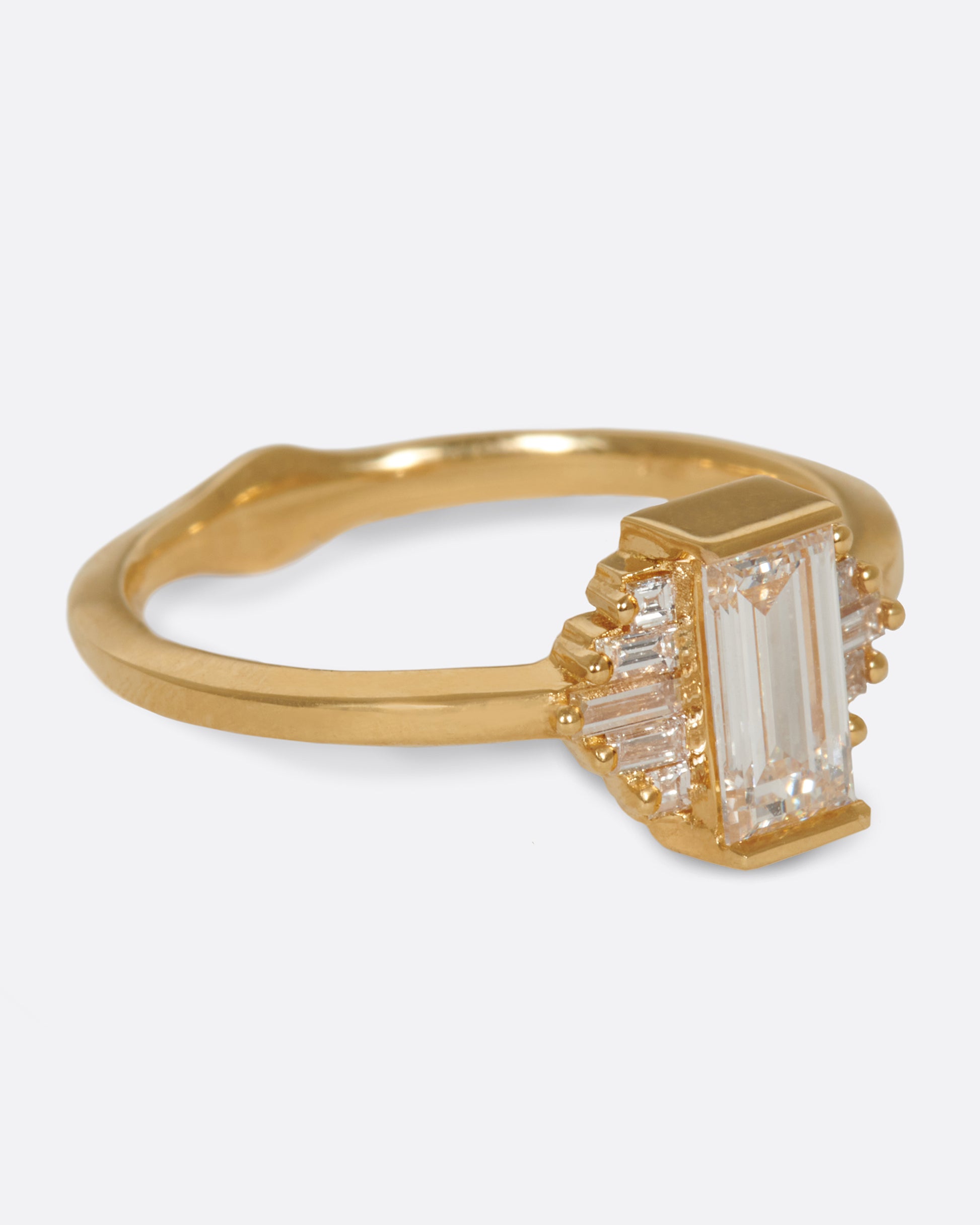 A large diamond baguette sits at the center of this ring, flanked by five additional baguettes on either side.