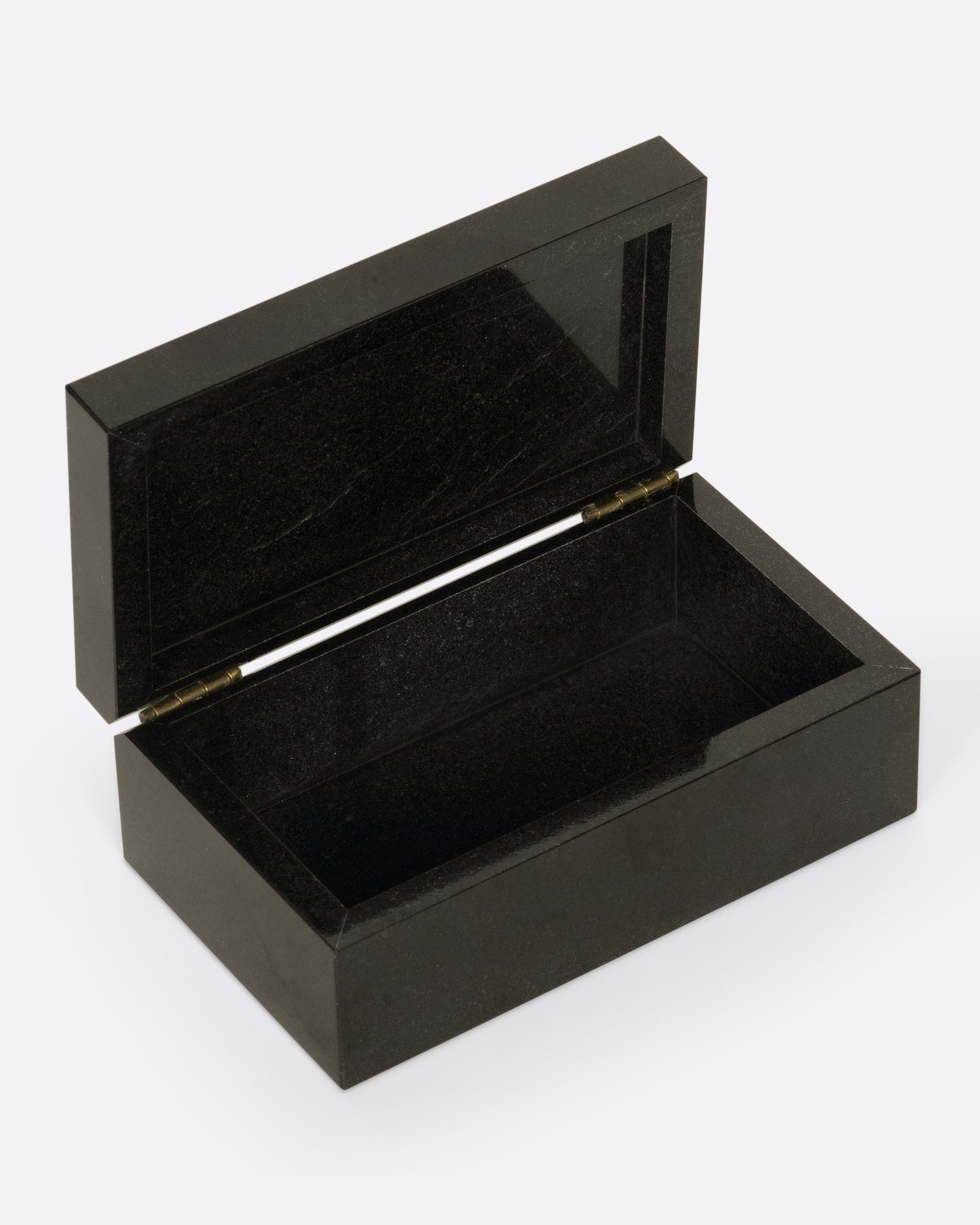 A hinged box made from dark igneous rock with a deep blue layer of lapis on the lid.