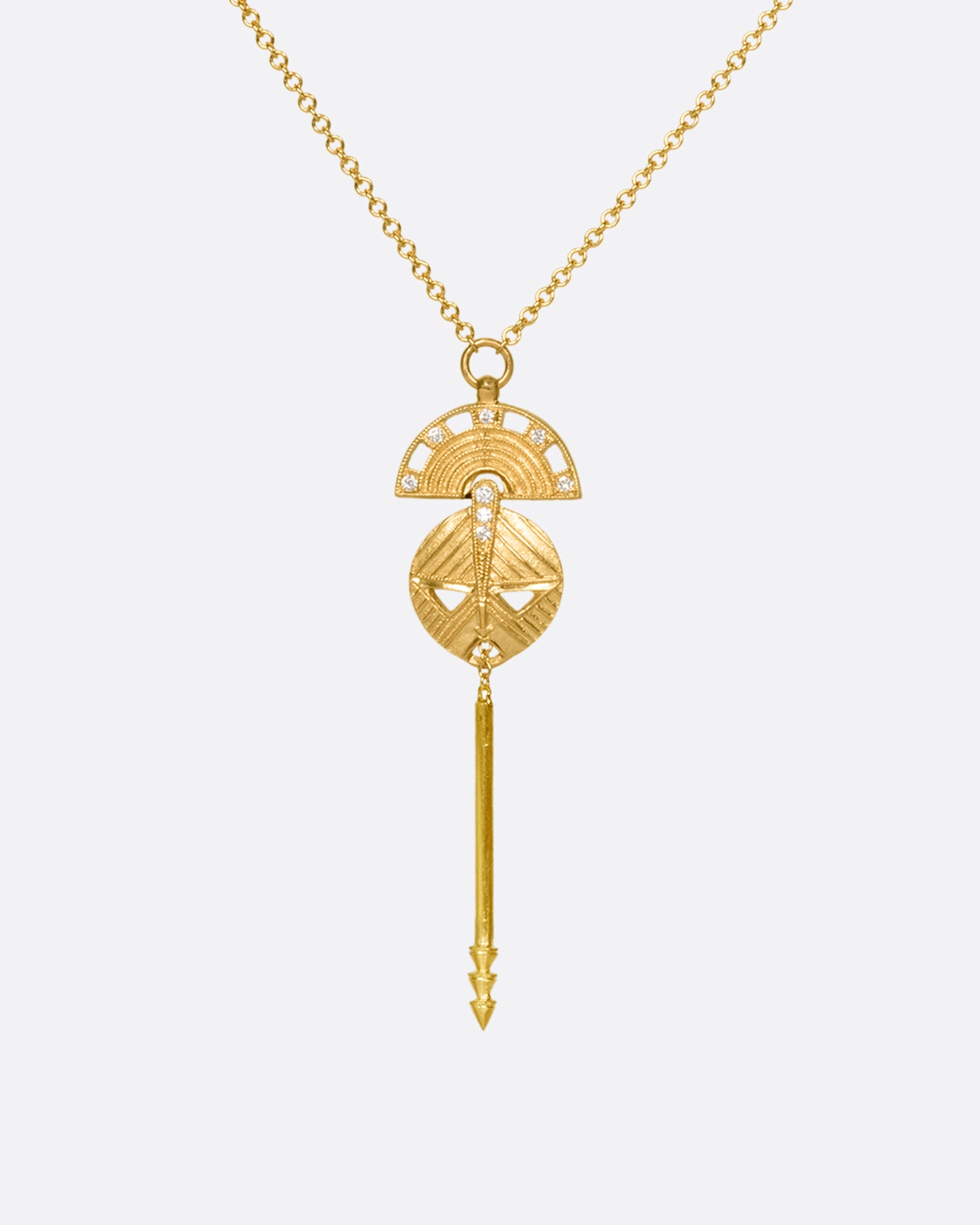 A long mask pendant with diamond accents hangs on cable chain.