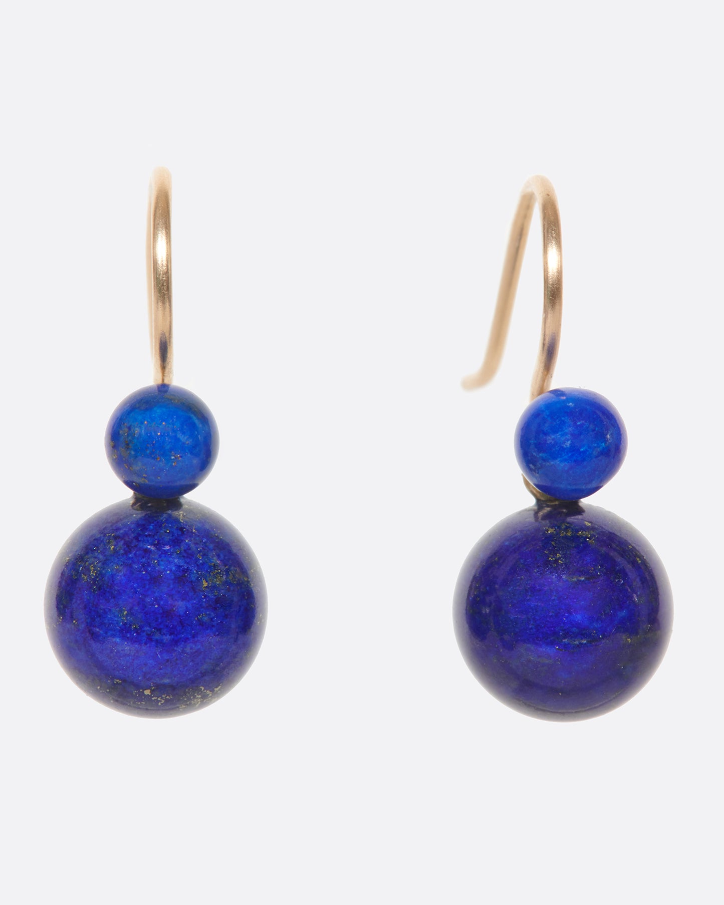 Two natural lapis spheres hang to create a contemporary geometric earring. Each pair is slightly different, as malachite has variations in its color naturally. 