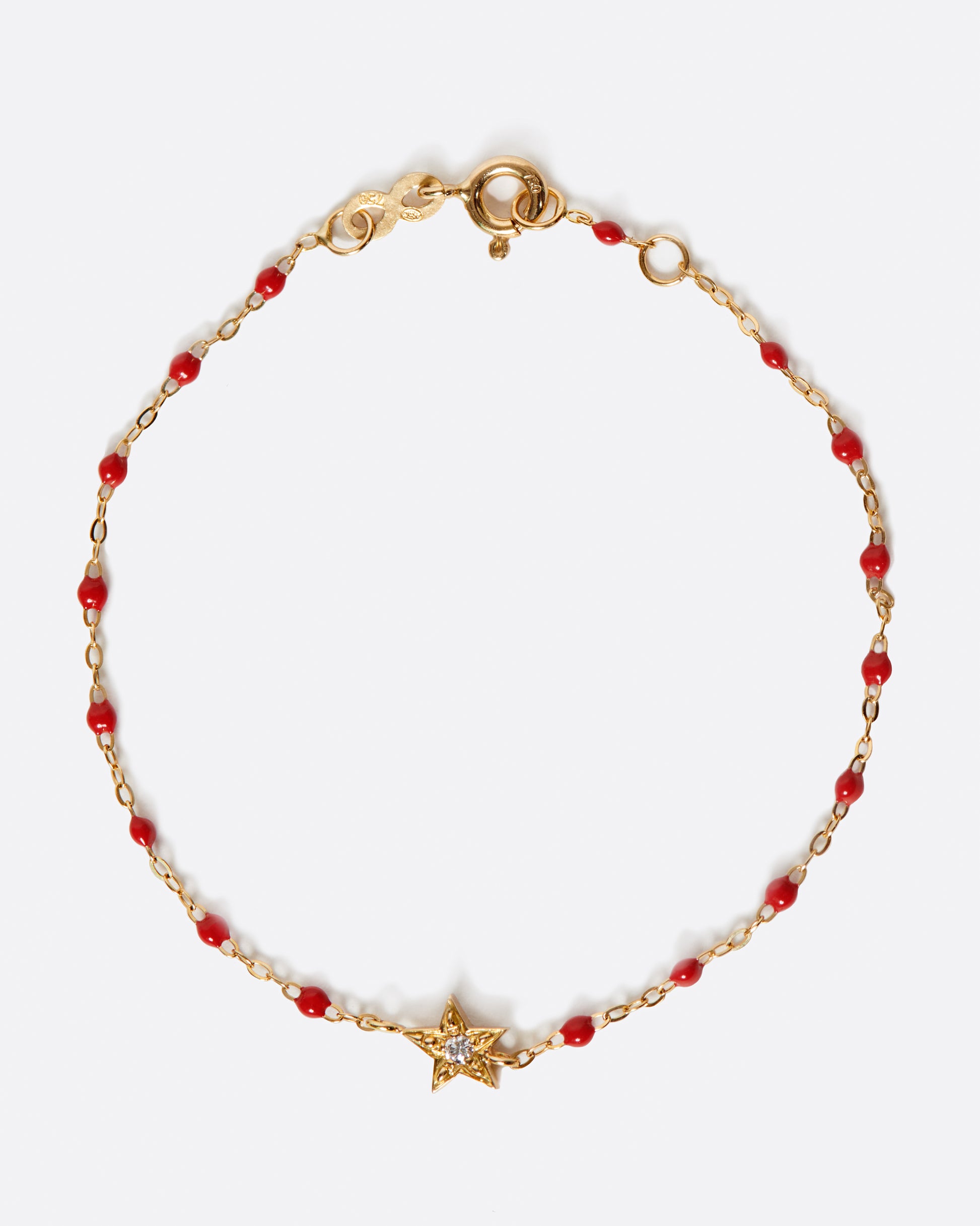 A classic Gigi Clozeau bracelet with poppy red resin and a five point star at its center.