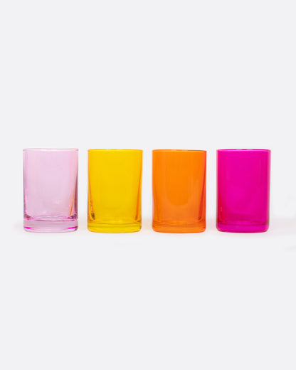 Four glass shot glasses in shades of pink, orange, and yellow. Shown from the front.