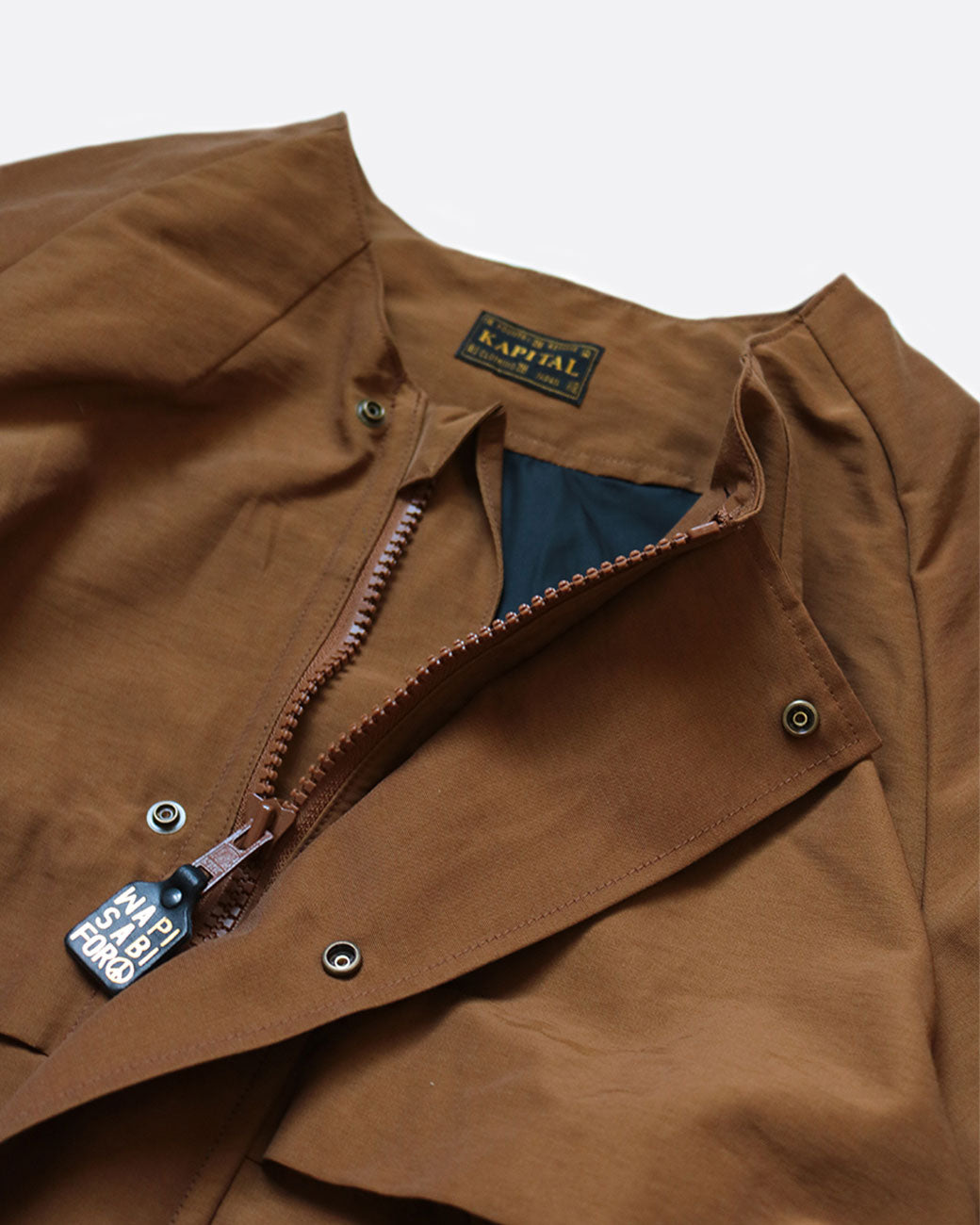 A brown parka with a zipper front. snap buttons, and black lining. Shown close up from the front.