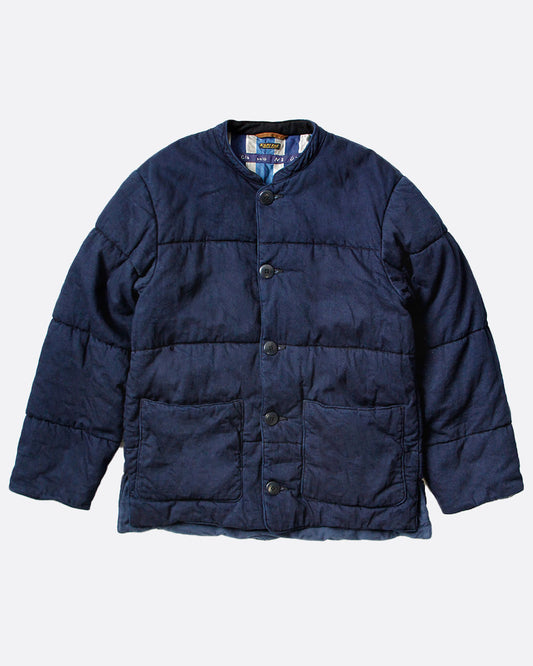 Kapital quilted denim jacket with button closure and two front pockets, shown laying flat.