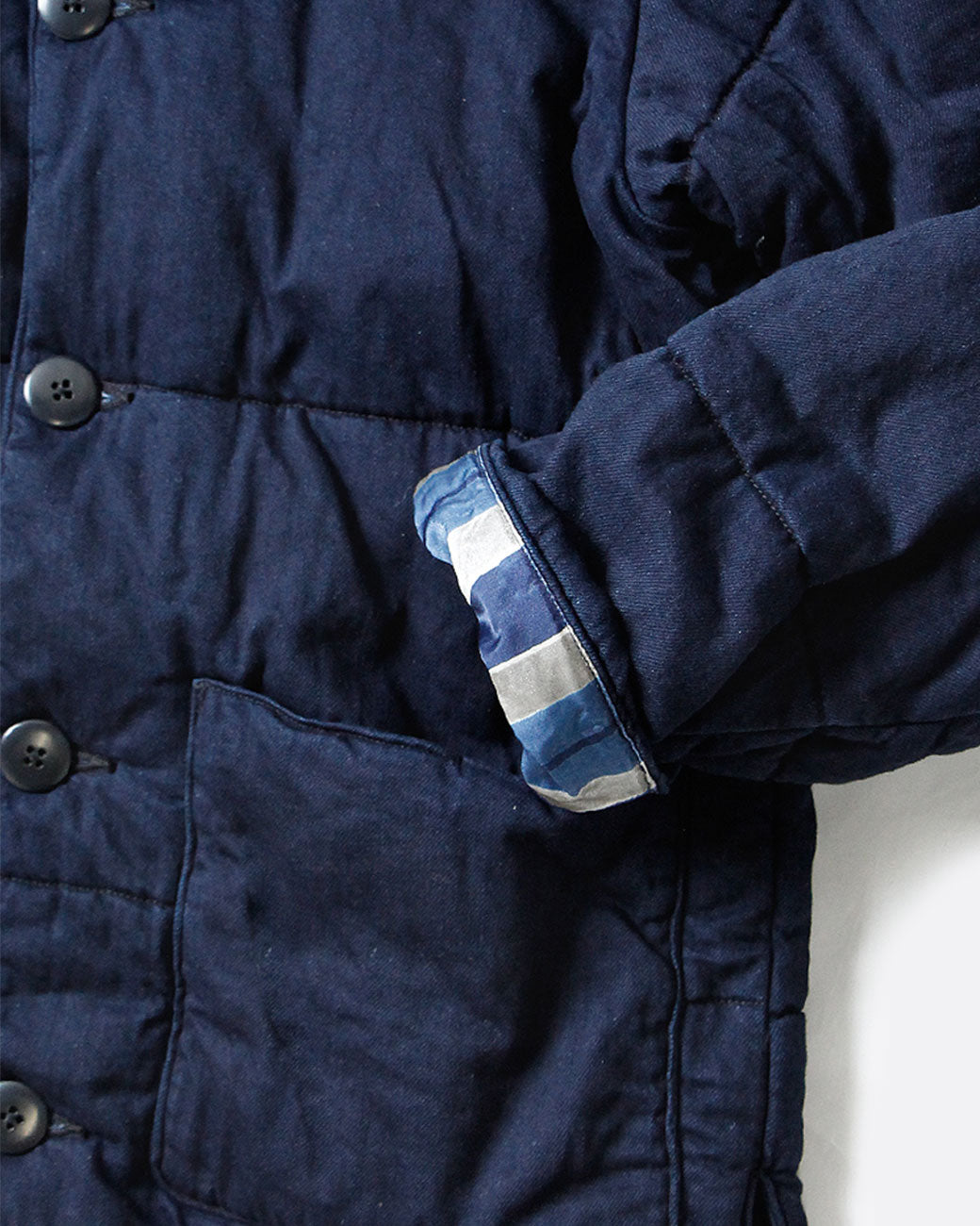 Close up of the sleeves of Kapital quilted denim jacket.