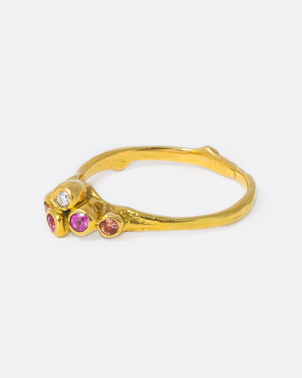 18k yellow gold teeny sea anemone ring with pink sapphires, orange sapphires, and diamonds by Kimberlin Brown, shown from the side.