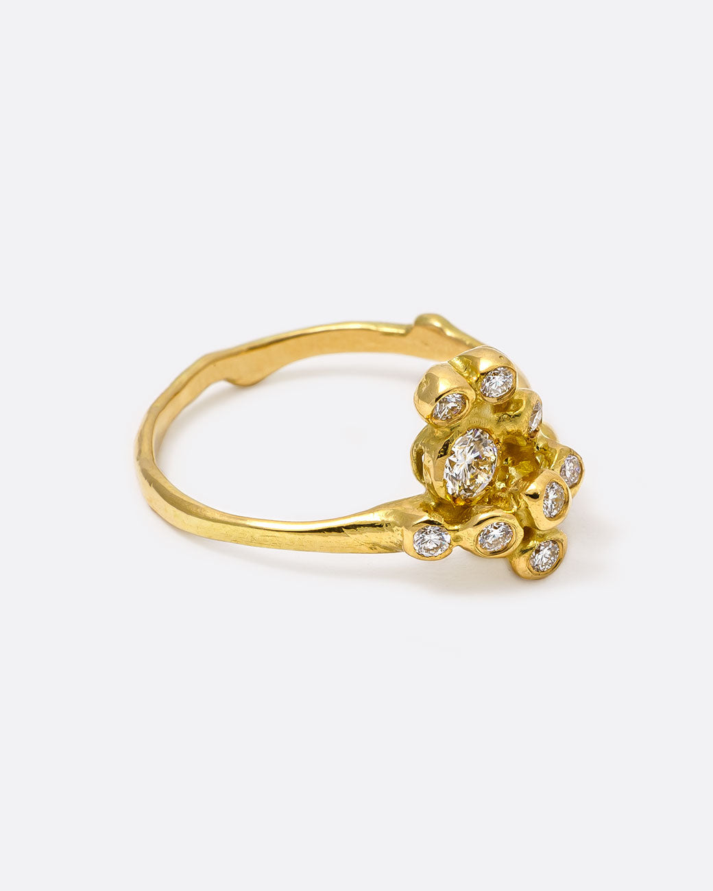 18k yellow gold blooming anemone ring with nine round diamonds by Kimberlin Brown, shown from the side.