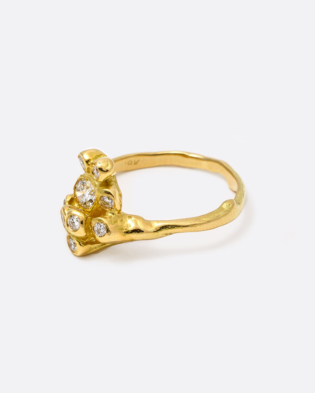 18k yellow gold blooming anemone ring with nine round diamonds by Kimberlin Brown, shown from the side.