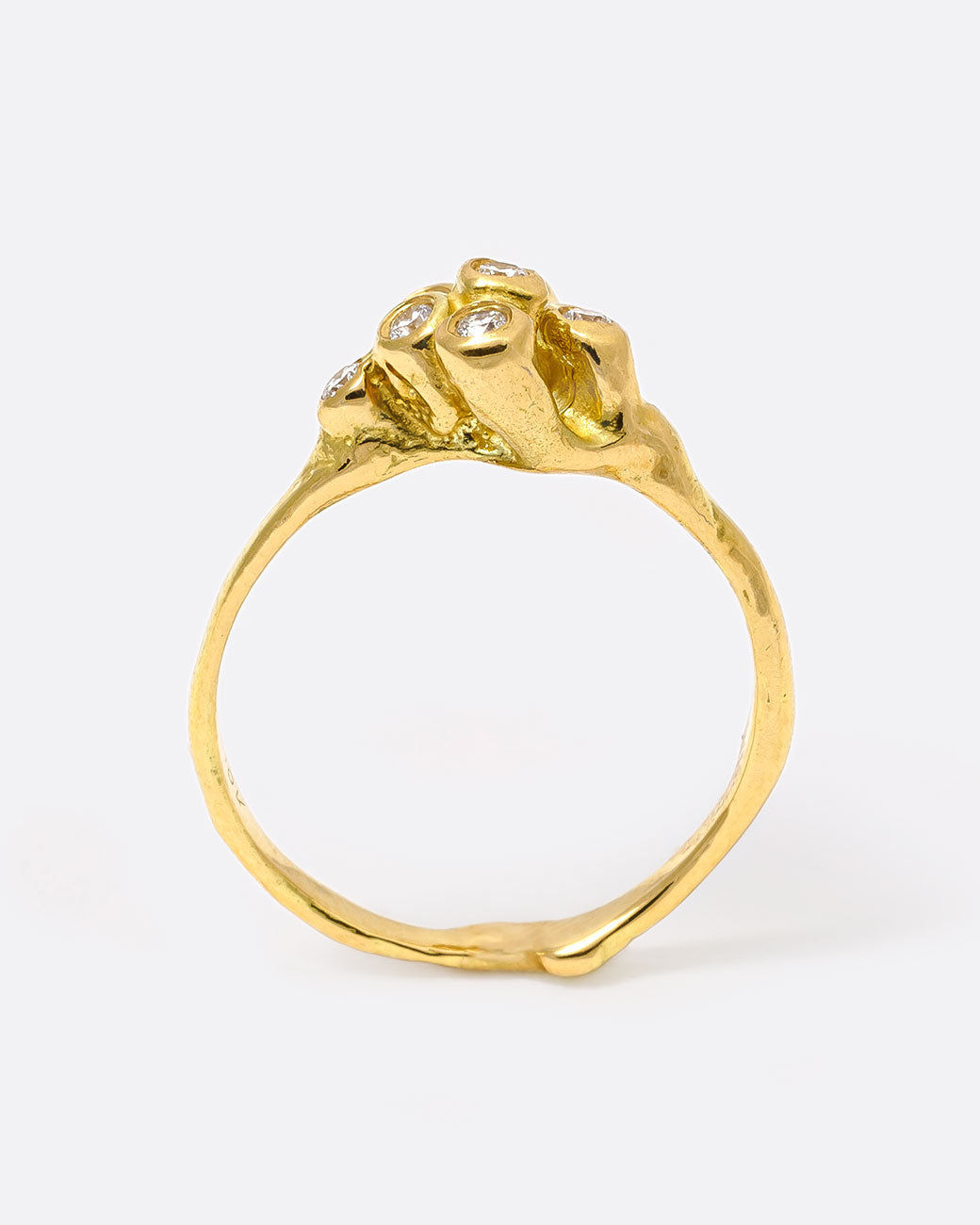 18k yellow gold blooming anemone ring with nine round diamonds by Kimberlin Brown, shown from the side.