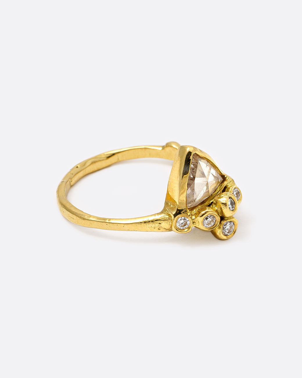 18k yellow gold anemone ring with triangular rose cut diamond and five round diamonds by Kimberlin Brown, shown from the side.