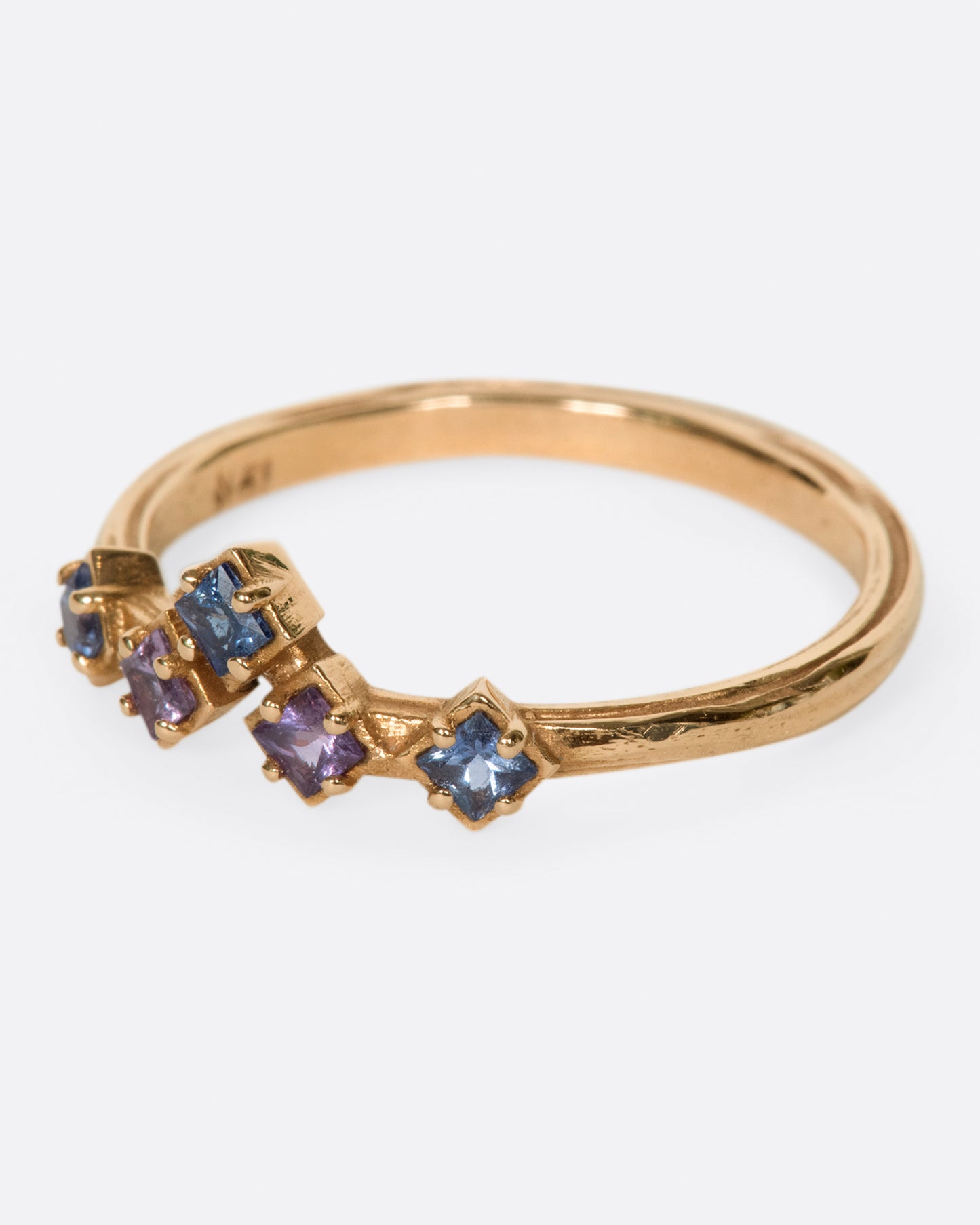 Inspired by the architecture of Tokyo, this curved band features princess cut blue and purple sapphires.