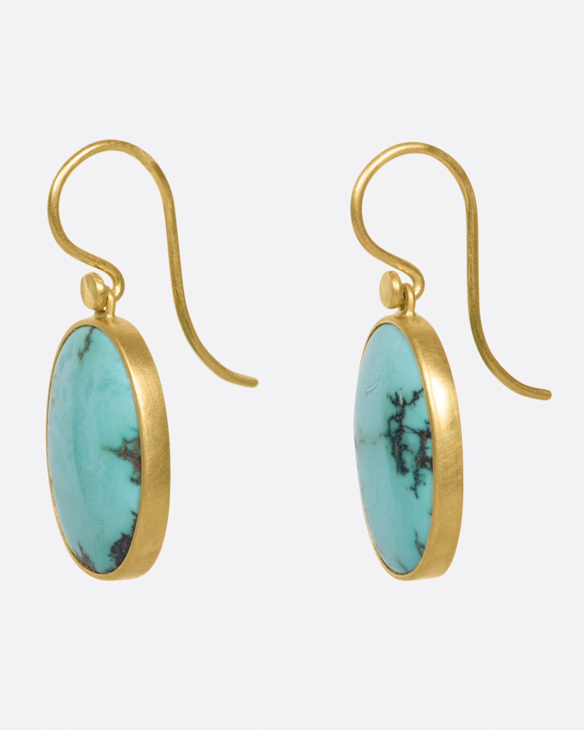 A pair of oval Tibetan turquoise drops set in Lola Brooks' signature bezel settings.