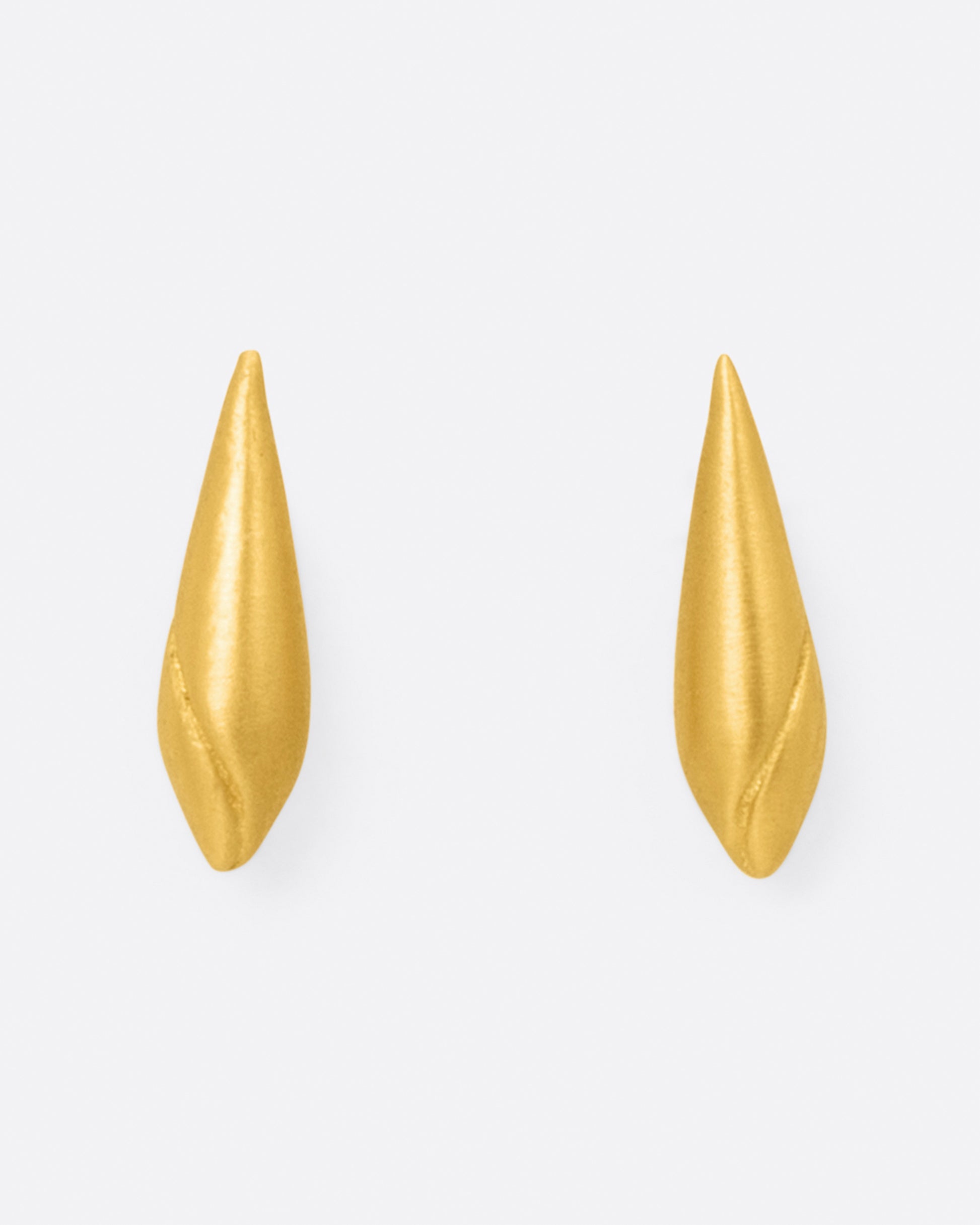 A pair of cone shaped 22k yellow gold stud earrings with a line following the curve of the earring, shown from the front.