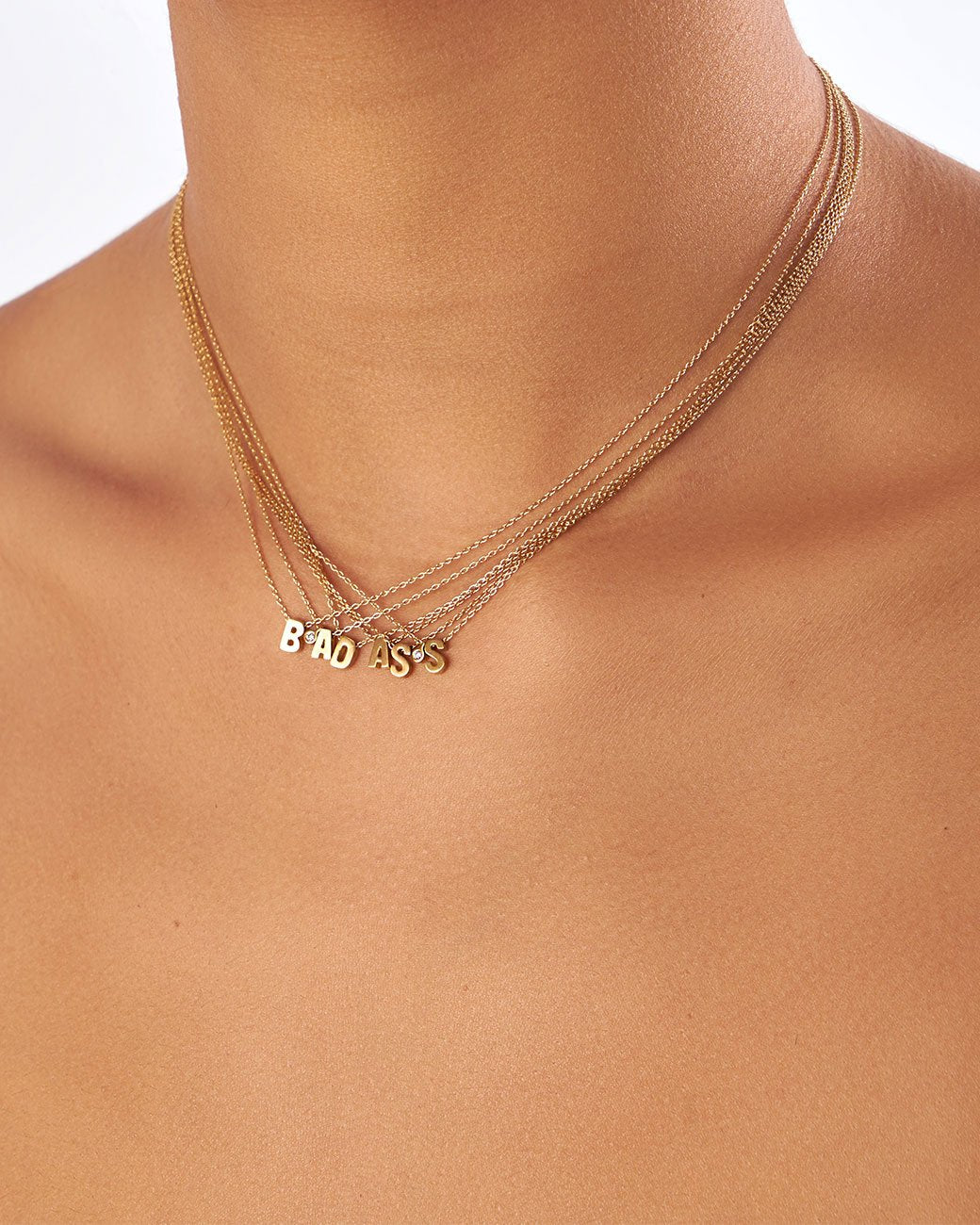 This micro initial necklace features a block letter of your choice hanging from a cable chain with an optional separate bezel set diamond tag.